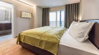 a bedroom with a bed with a pillow and a window at Penthouse Skygarden in Schenna
