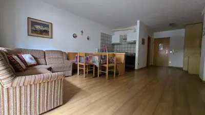 a living room with a couch and a table at Appartamenti Bernard Sas in Canazei