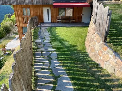 a stone path in front of a house at Brentwaldhof Appartements in Cornedo all'Isarco