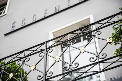 a building with a wrought iron railing in front of a window at Eggentaler in Bolzano