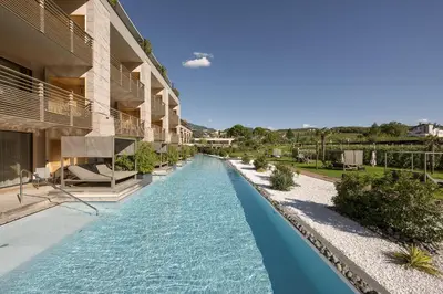 a swimming pool in the middle of a building at Weinegg Wellviva Resort in Appiano sulla Strada del Vino