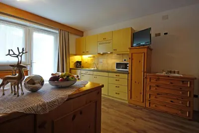 a kitchen with a bowl of fruit on a table at Piz da Cir in Colfosco