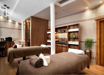 a room with two beds in a room at Hotel Alpenroyal - The Leading Hotels of the World in Selva di Val Gardena