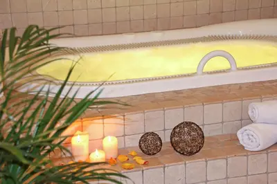 a bathroom with candles and a bath tub with at Pension Tasa in Valles