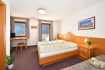 a hotel room with a bed and a desk at Pension Tasa in Valles