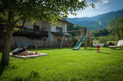 a group of people playing on a playground at Ferienwohnung Mair am Bach in Brunico