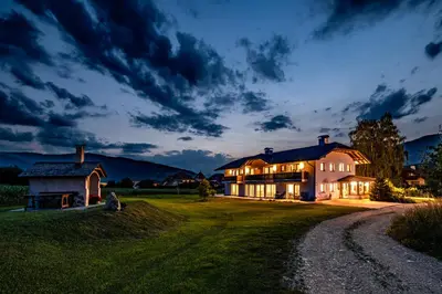 a large house on a field at night at Ferienwohnung Mair am Bach in Brunico