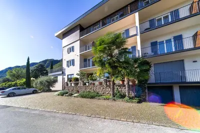 a building with a palm tree in front of it at Pension Gruenwald in Andrian