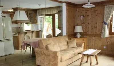 a living room with a couch and a table at Family and Wellness Residence Ciasa Antersies in San Cassiano