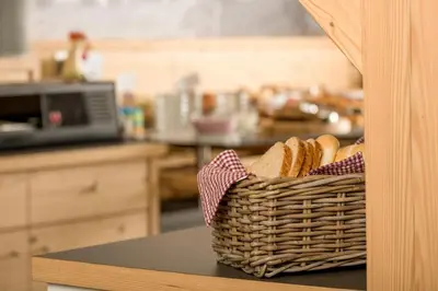 a basket of bread sitting on a counter in a kitchen at Hotel Garni Lastei in Pozza di Fassa