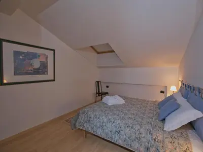 a bedroom with a bed and a picture on the wall at Apartment in Predazzo near Dolomiti Superski in Predazzo