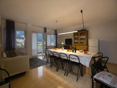 a kitchen and living room with a table and chairs at Apartment in Predazzo near Dolomiti Superski in Predazzo