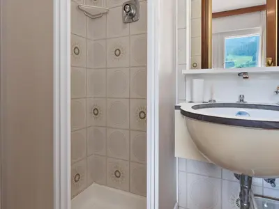a bathroom with a sink and a shower at Apartment in Predazzo near Dolomites Trails in Predazzo