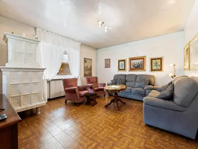 a living room with a blue couch and chairs at Apartment in Predazzo near Dolomites Trails in Predazzo