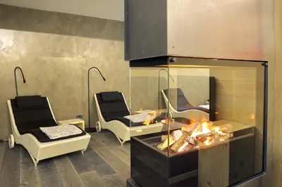 a room with two chairs and a table and a mirror at Astor Suites B&B in Selva di Val Gardena