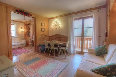 a living room with a table and a couch at Botton d'oro in Borca di Cadore