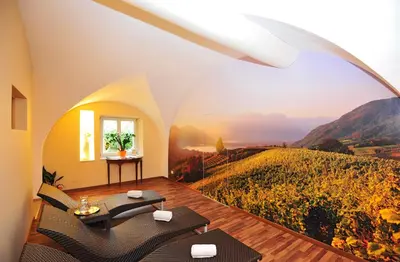 a dining room with tables and chairs with white table cloth at Hotel Andreas Hofer in Egna