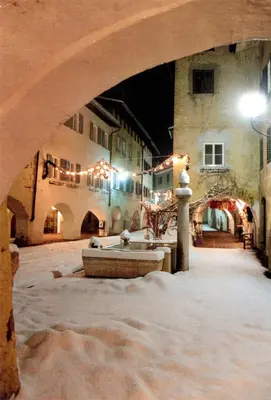 a restaurant with tables and chairs with white tablecloths at Hotel Andreas Hofer in Egna