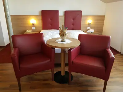 a hallway with an archway in a building with a table at Hotel Andreas Hofer in Egna