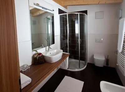 a bathroom with a sink and a shower and a toilet at Antorè in Badia