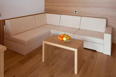 a living room with a couch and a bowl of fruit on a table at Antorè in Badia