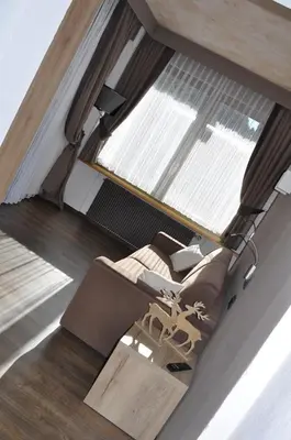 a room with two chairs and a table and a window at Residence Anda in Pozza di Fassa