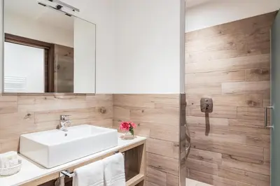 a bathroom with a sink and a mirror at Residence Anda in Pozza di Fassa