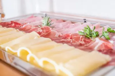 a tray of cheese and meats on a table at Garni Volgger in Brunico