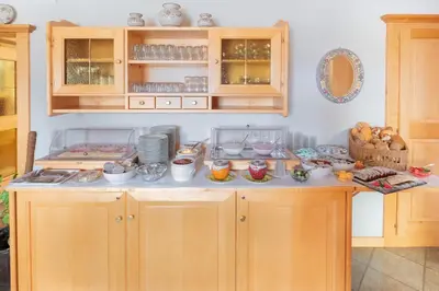 a kitchen with a counter with dishes on it at Garni Volgger in Brunico