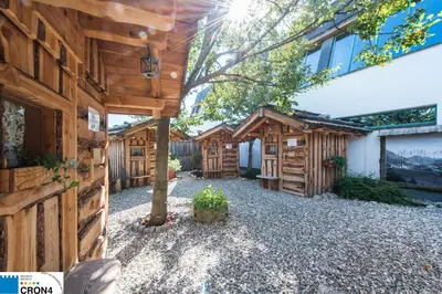 a backyard with a wooden fence and a tree at Garni Volgger in Brunico