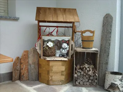 a wooden bird house with a stuffed animal sitting on a chest at Ferienwohnung Winklerhof in Maranza