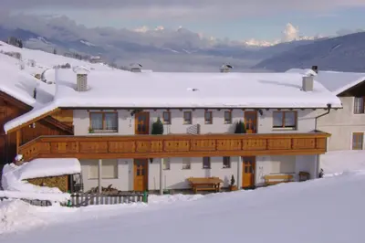 a house with snow on the roof at Ferienwohnung Winklerhof in Maranza