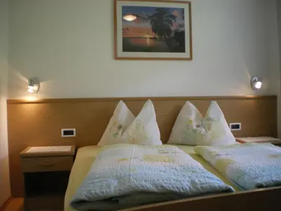 a bedroom with a bed with pillows on it at Ferienwohnung Winklerhof in Maranza