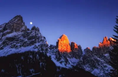 a mountain range with the moon in the background at Hotel Paladin in San Martino di Castrozza