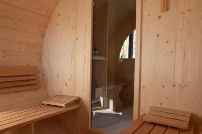 a bedroom with a bed and a mirror on the wall at Haller Suites & Restaurant in Bressanone