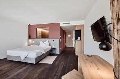 a house with glass walls and a dining room at Haller Suites & Restaurant in Bressanone