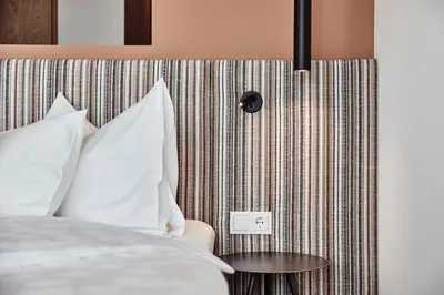 two girls laying on beds in a room with a view at Haller Suites & Restaurant in Bressanone