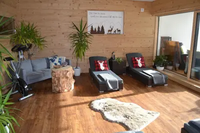 a living room with a couch and two chairs at Cesa Prinoth in Campitello di Fassa