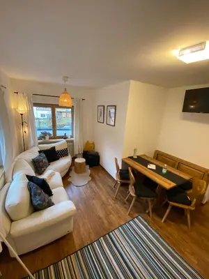 a living room with a couch and a table at Cesa Prinoth in Campitello di Fassa
