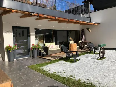 a patio with chairs and a couch in a house at Cesa Prinoth in Campitello di Fassa