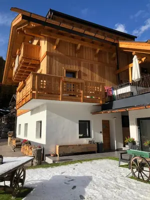 a large building with a balcony and a deck at Cesa Prinoth in Campitello di Fassa