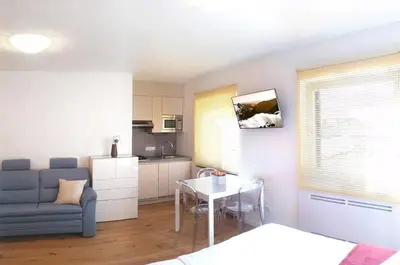 a living room with a couch and a table and a kitchen at Traubenhof in Magrè allʼ Adige