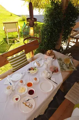 a table with plates of food on it at Schiessstandhof in Montagna