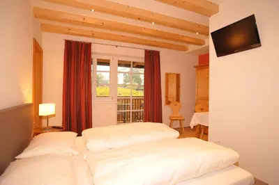 a bedroom with two beds and a window at Schiessstandhof in Montagna