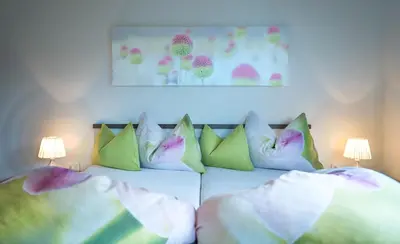 a bedroom with a bed with pillows on it at Niederhof life in Lana