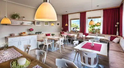 a restaurant with tables and chairs in a room at Niederhof life in Lana