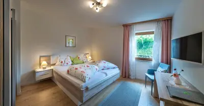 a small room with a bed and a table at Niederhof life in Lana