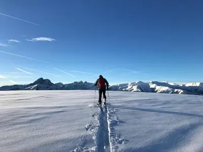 a person is cross country skiing in the snow at Zur Brücke apartments and rooms - Your home in heart of South Tyrol, with Brixencard in Fortezza