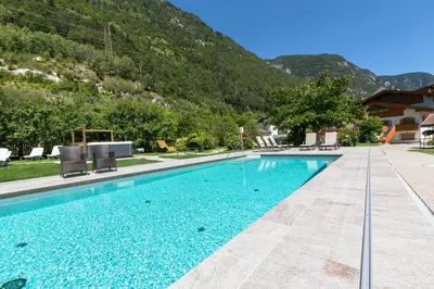 a swimming pool with a mountain in the background at Zur Brücke apartments and rooms - Your home in heart of South Tyrol, with Brixencard in Fortezza