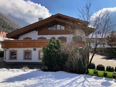 a house with snow in front of it at Zur Brücke apartments and rooms - Your home in heart of South Tyrol, with Brixencard in Fortezza